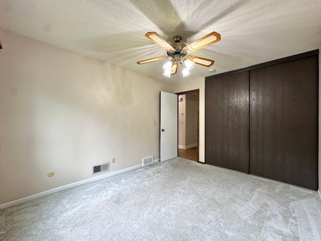 2360 3rd St NW, New Brighton, MN 55112 - unfurnished bedroom with carpet, a closet, a ceiling fan, and a textured ceiling