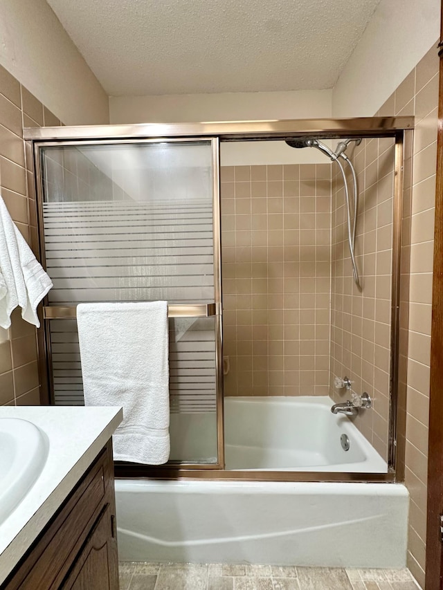 2360 3rd St NW, New Brighton, MN 55112 - bathroom with combined bath / shower with glass door, vanity, and a textured ceiling