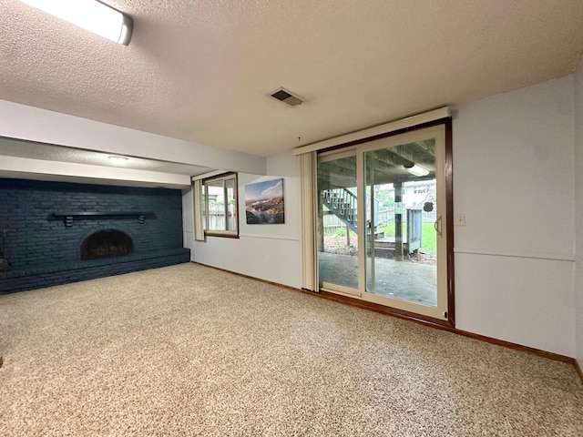 2360 3rd St NW, New Brighton, MN 55112 - unfurnished living room featuring a fireplace, a textured ceiling, and carpet flooring