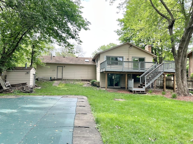 2360 3rd St NW, New Brighton, MN 55112 - rear view of house featuring a wooden deck, stairway, a chimney, a yard, and a storage unit