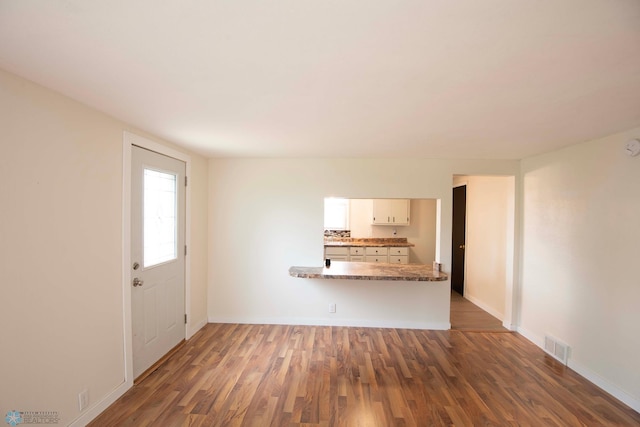 405 18th St N, Moorhead, MN 56560 - unfurnished living room featuring wood finished floors and baseboards