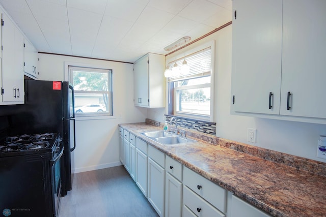 405 18th St N, Moorhead, MN 56560 - kitchen with black gas range oven and white cabinetry