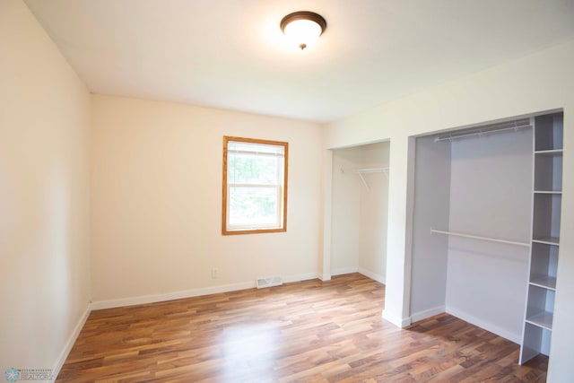 405 18th St N, Moorhead, MN 56560 - unfurnished bedroom featuring wood finished floors