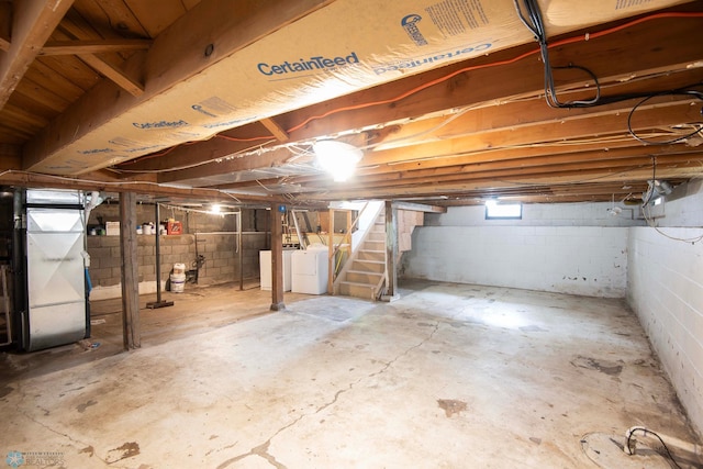 405 18th St N, Moorhead, MN 56560 - basement with stairway, heating unit, and independent washer and dryer