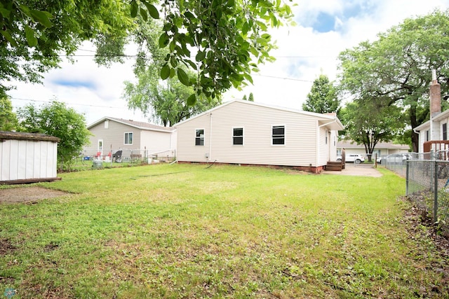 405 18th St N, Moorhead, MN 56560 - rear view of property featuring a fenced backyard and a shed