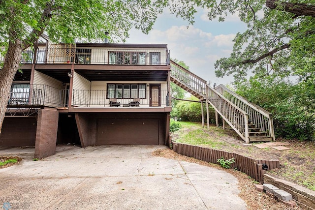 722 Elm St N Unit A8, Fargo, ND 58102 - view of front of house with stairs, an attached garage, concrete driveway, and a wooden deck