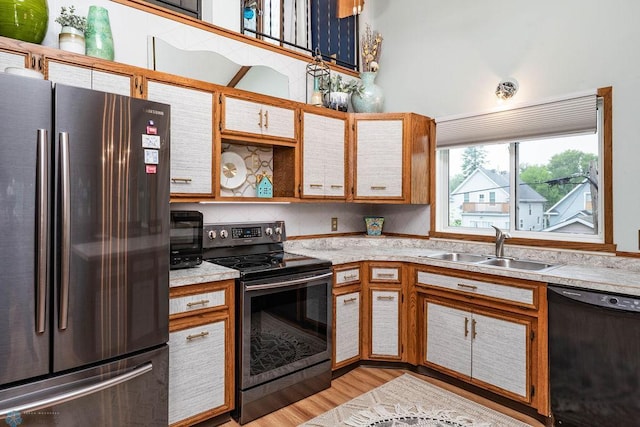 722 Elm St N Unit A8, Fargo, ND 58102 - kitchen featuring stainless steel appliances, light countertops, open shelves, and light wood-style floors