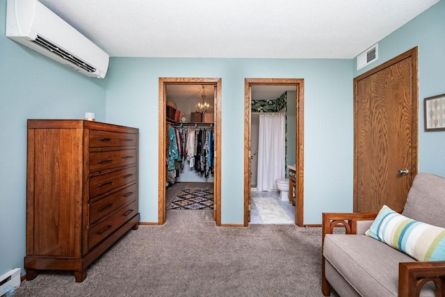 722 Elm St N Unit A8, Fargo, ND 58102 - living area featuring a wall mounted air conditioner, light carpet, and a chandelier
