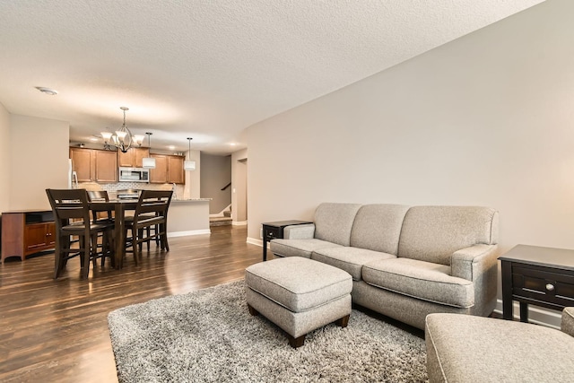 9902 5th Street Ln N, Lake Elmo, MN 55042 - living room featuring stairs, a chandelier, and dark wood-type flooring