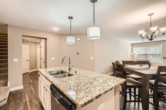 9902 5th Street Ln N, Lake Elmo, MN 55042 - kitchen featuring dishwasher, dark wood-type flooring, a center island with sink, decorative light fixtures, and light stone countertops