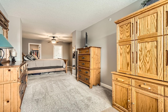 9902 5th Street Ln N, Lake Elmo, MN 55042 - bedroom with light carpet, a textured ceiling, and a walk in closet