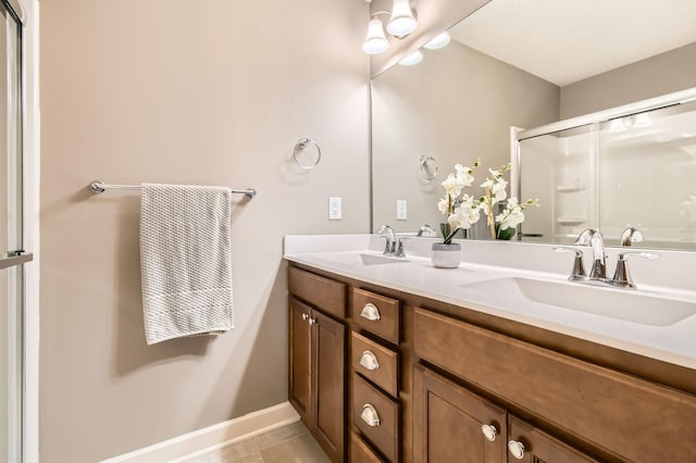 9902 5th Street Ln N, Lake Elmo, MN 55042 - full bath featuring double vanity, a shower with door, and tile patterned flooring