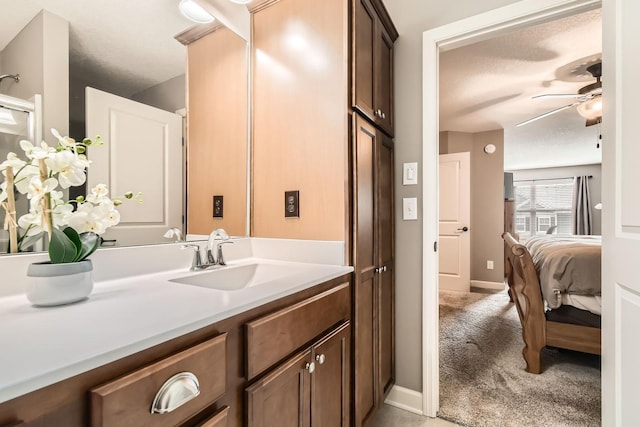9902 5th Street Ln N, Lake Elmo, MN 55042 - bathroom featuring vanity, a textured ceiling, a ceiling fan, and ensuite bath