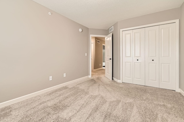 9902 5th Street Ln N, Lake Elmo, MN 55042 - unfurnished bedroom featuring carpet, a textured ceiling, and a closet