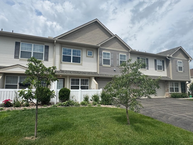 9902 5th Street Ln N, Lake Elmo, MN 55042 - townhome / multi-family property featuring driveway, a garage, and a front lawn