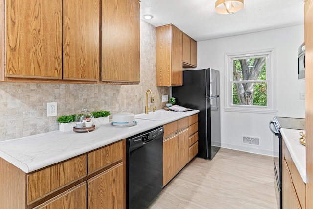 1007 Ingerson Rd, Shoreview, MN 55126 - kitchen with dishwasher, electric stove, tasteful backsplash, light countertops, and light wood-style flooring