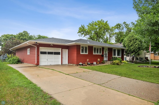 2319 10th St S, Fargo, ND 58103 - single story home featuring an attached garage, driveway, and a front lawn