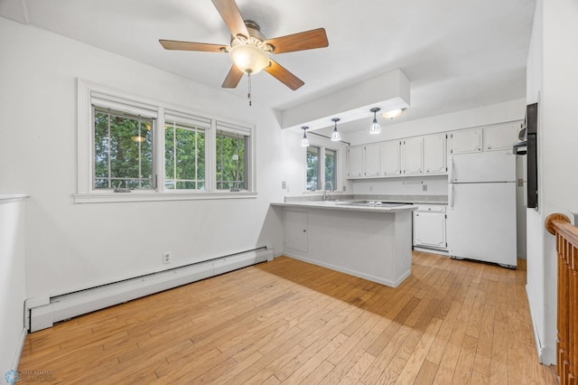 2319 10th St S, Fargo, ND 58103 - kitchen featuring freestanding refrigerator, a baseboard heating unit, a peninsula, white cabinets, and a ceiling fan