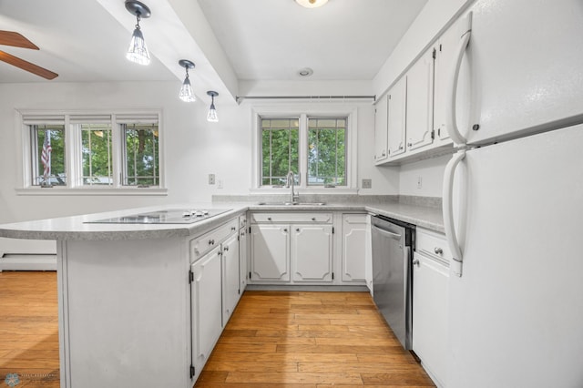 2319 10th St S, Fargo, ND 58103 - kitchen with freestanding refrigerator, dishwasher, a peninsula, electric stovetop, and healthy amount of natural light