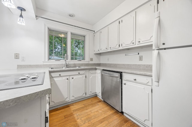 2319 10th St S, Fargo, ND 58103 - kitchen featuring white appliances, white cabinets, light wood-style floors, and light countertops