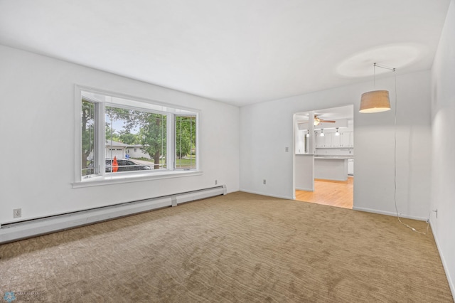 2319 10th St S, Fargo, ND 58103 - spare room with a baseboard radiator, carpet flooring, and a ceiling fan