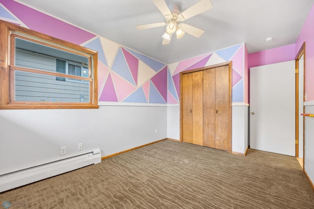 2319 10th St S, Fargo, ND 58103 - unfurnished bedroom featuring a baseboard radiator, carpet flooring, a closet, and ceiling fan