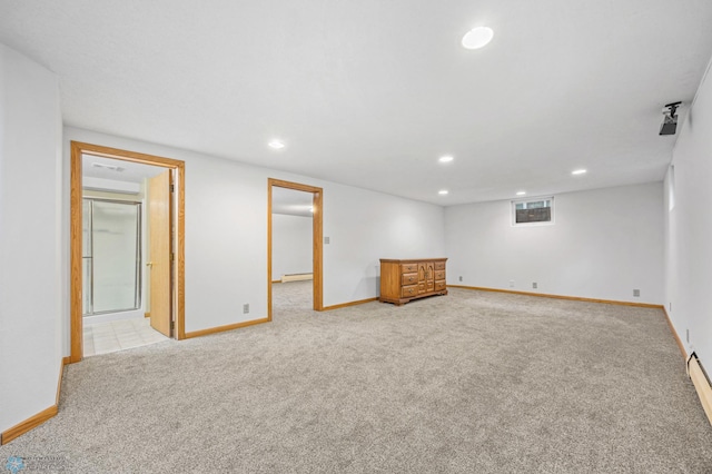 2319 10th St S, Fargo, ND 58103 - finished below grade area featuring carpet floors, recessed lighting, a baseboard heating unit, and a baseboard radiator