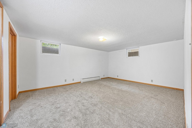 2319 10th St S, Fargo, ND 58103 - carpeted empty room with a baseboard heating unit and a textured ceiling