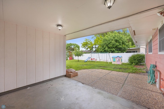 2319 10th St S, Fargo, ND 58103 - fenced backyard with a playground and a patio area