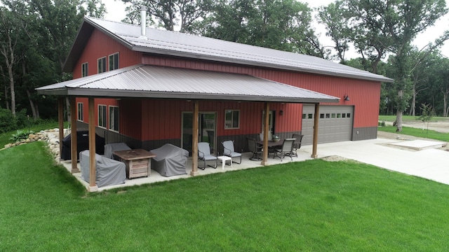14650 Hilltop Rd, Ashby, MN 56309 - rear view of house featuring a yard, a patio area, a metal roof, a garage, and driveway