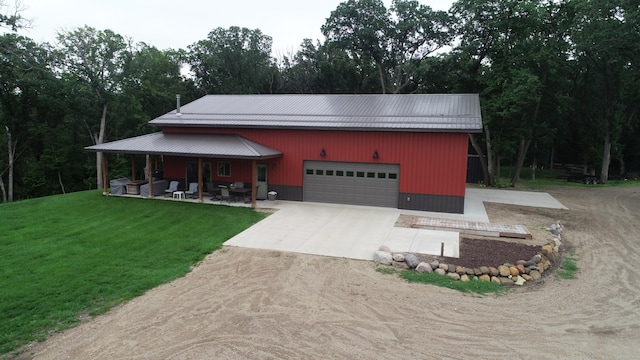 14650 Hilltop Rd, Ashby, MN 56309 - view of front of property featuring concrete driveway, a front yard, a garage, and a metal roof