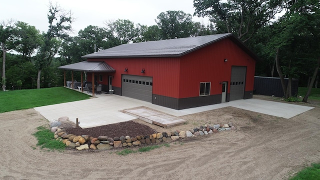 14650 Hilltop Rd, Ashby, MN 56309 - view of front of home featuring a metal roof, a front lawn, an outbuilding, and a garage