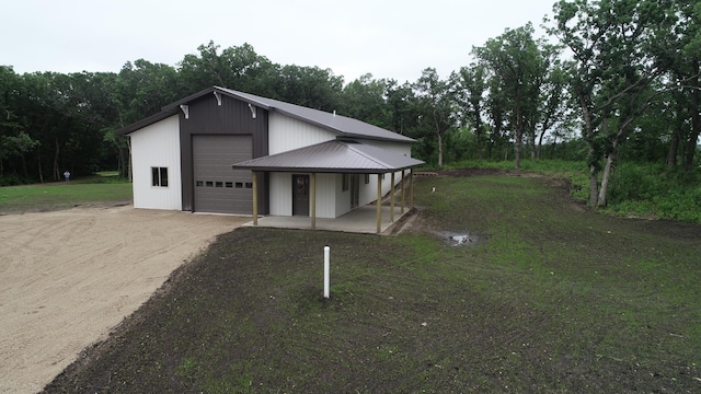 14650 Hilltop Rd, Ashby, MN 56309 - view of front of house with a detached garage, driveway, a porch, and a metal roof