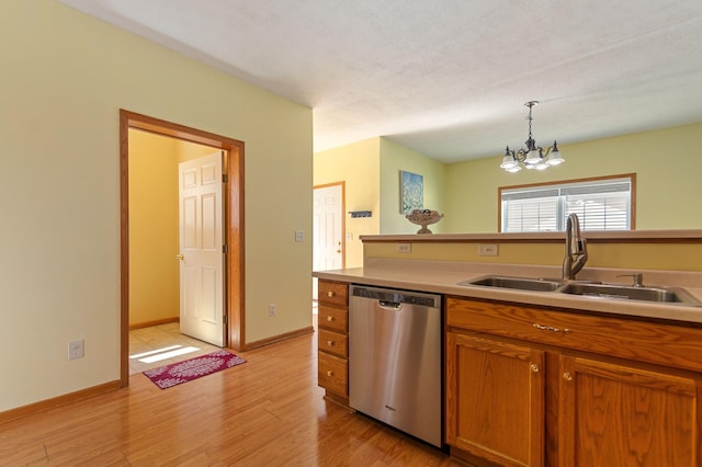 114006 Hundertmark Rd, Chaska, MN 55318 - kitchen featuring dishwasher, a chandelier, brown cabinets, light wood-type flooring, and hanging light fixtures