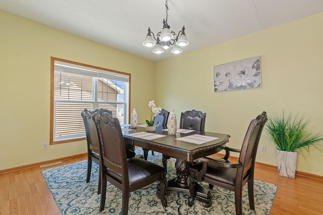 114006 Hundertmark Rd, Chaska, MN 55318 - dining area featuring a chandelier and light wood-style flooring
