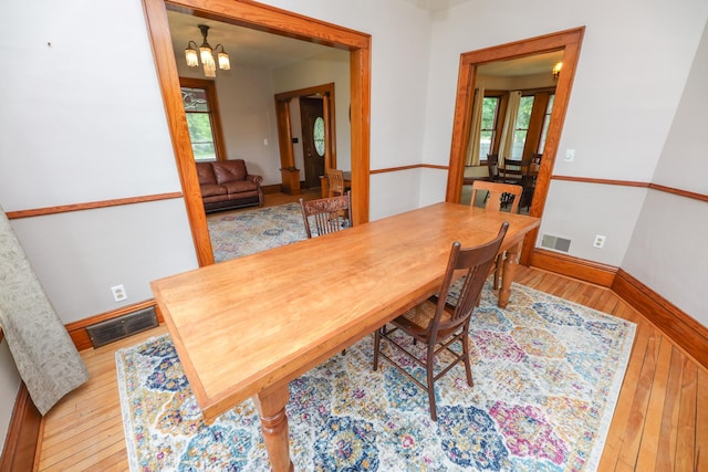 1122 Fillmore St, Alexandria, MN 56308 - dining room with hardwood / wood-style flooring and a chandelier