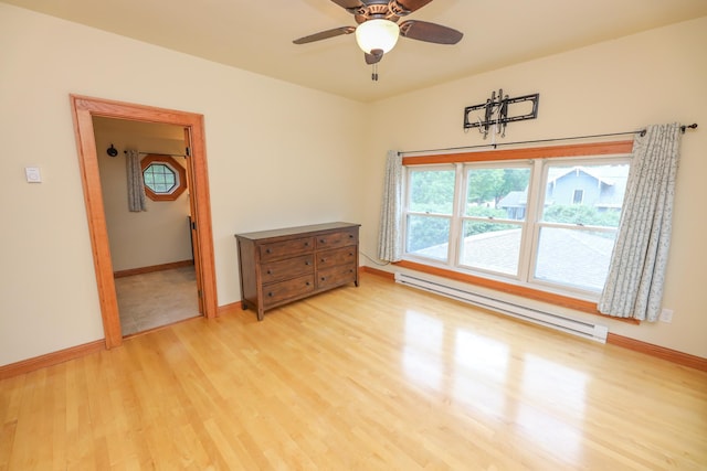 1122 Fillmore St, Alexandria, MN 56308 - empty room with baseboard heating, light wood finished floors, and ceiling fan