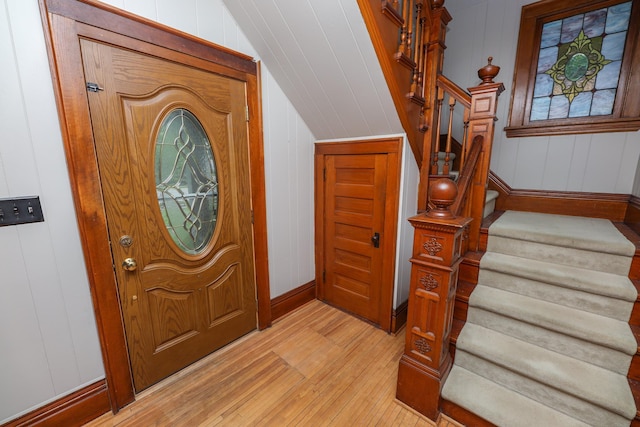 1122 Fillmore St, Alexandria, MN 56308 - foyer entrance featuring stairs, light wood-style floors, lofted ceiling, and a decorative wall