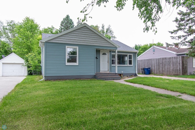 634 11th St N, Moorhead, MN 56560 - view of front of house with an outdoor structure, a garage, and concrete driveway