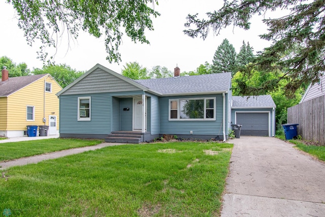 634 11th St N, Moorhead, MN 56560 - view of front of property with driveway, a chimney, a front yard, and a shingled roof