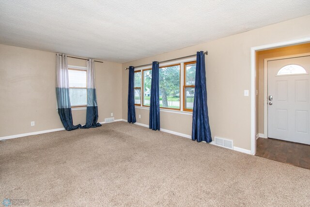 634 11th St N, Moorhead, MN 56560 - empty room with carpet flooring and a textured ceiling