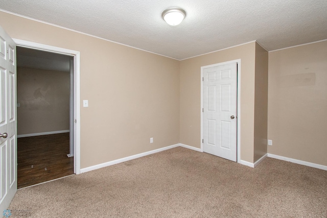 634 11th St N, Moorhead, MN 56560 - unfurnished bedroom with carpet, a textured ceiling, and ornamental molding