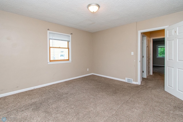634 11th St N, Moorhead, MN 56560 - carpeted empty room with a textured ceiling and baseboards