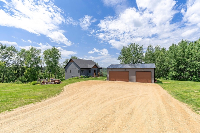 26887 709th St, Lake City, MN 55041 - view of front of property featuring driveway, an outdoor structure, a front yard, and a detached garage