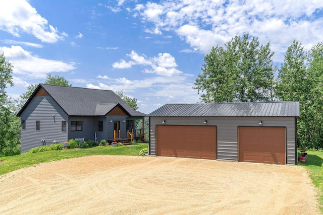 26887 709th St, Lake City, MN 55041 - view of front of property with dirt driveway, an outbuilding, and a metal roof