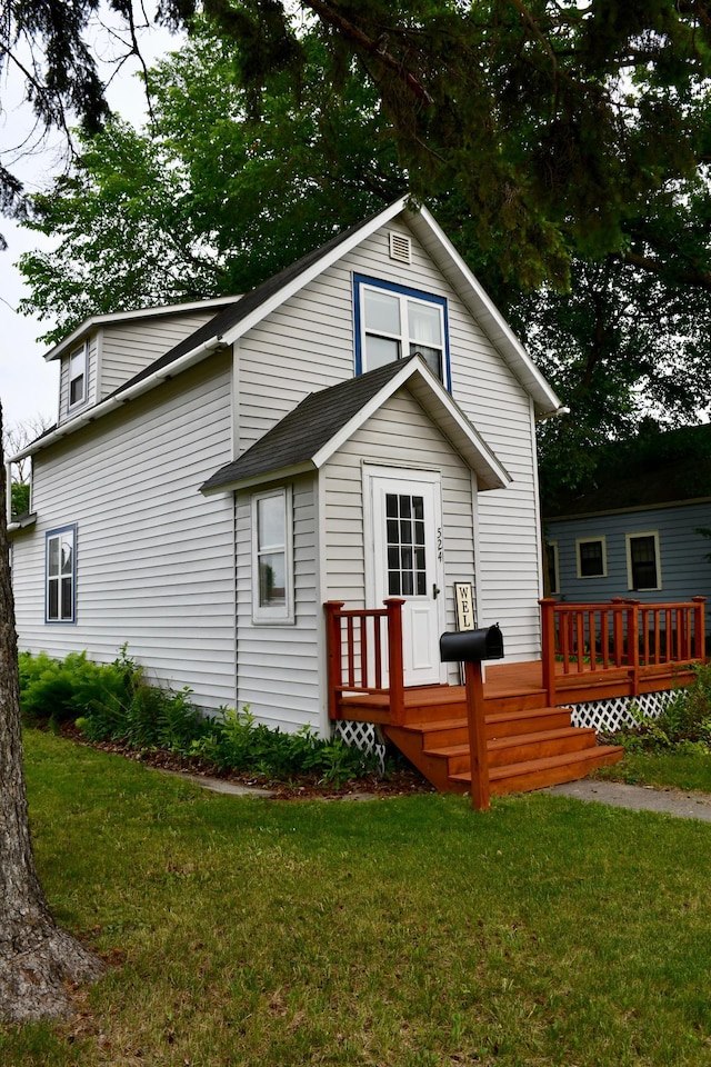 524 Horace Ave N, Thief River Falls, MN 56701 - view of front of house with a deck and a front yard
