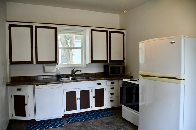 524 Horace Ave N, Thief River Falls, MN 56701 - kitchen with white appliances, dark countertops, and white cabinets