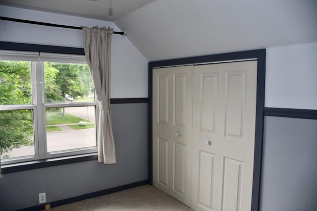 524 Horace Ave N, Thief River Falls, MN 56701 - unfurnished bedroom featuring vaulted ceiling, multiple windows, and a closet