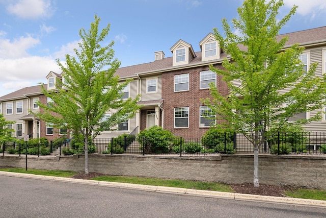 11350 Stratton Ave, Eden Prairie, MN 55344 - view of property with brick siding and a fenced front yard