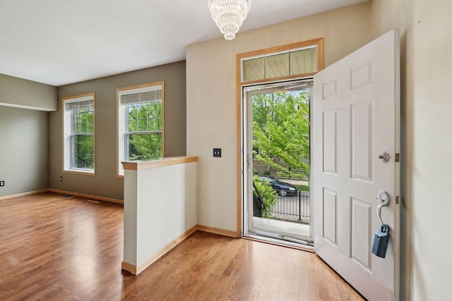 11350 Stratton Ave, Eden Prairie, MN 55344 - foyer featuring healthy amount of natural light, wood finished floors, and a chandelier